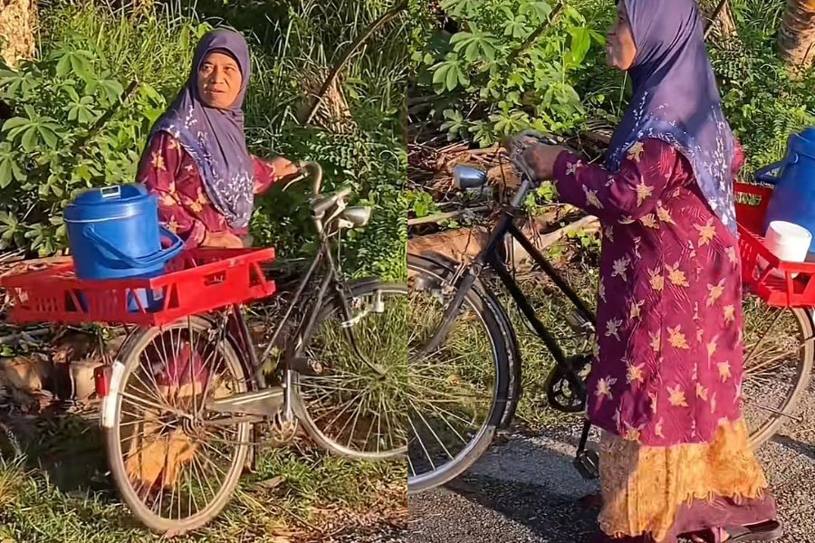 Makcik itu kelihatan gembira membawa nasi lemak untuk berniaga.