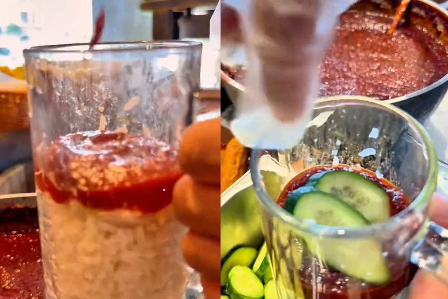 Nasi lemak dalam cawan lengkap diisi dengan nasi, sambal; timun; ikan bilis dan telur rebus sebiji.
